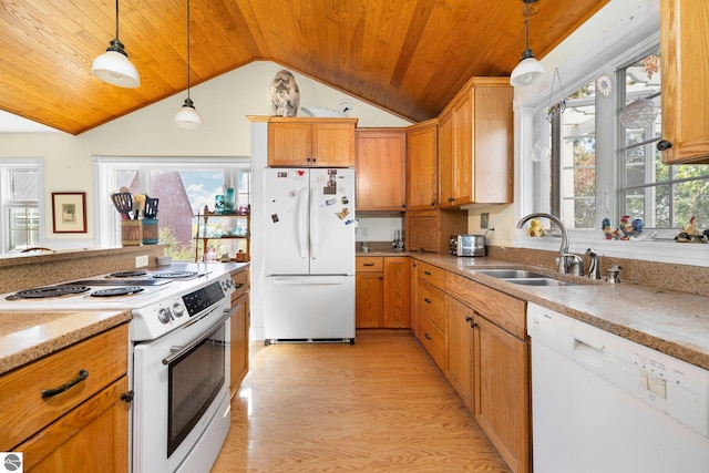 kitchen featuring vaulted ceiling, hanging light fixtures, white appliances, and light wood-type flooring