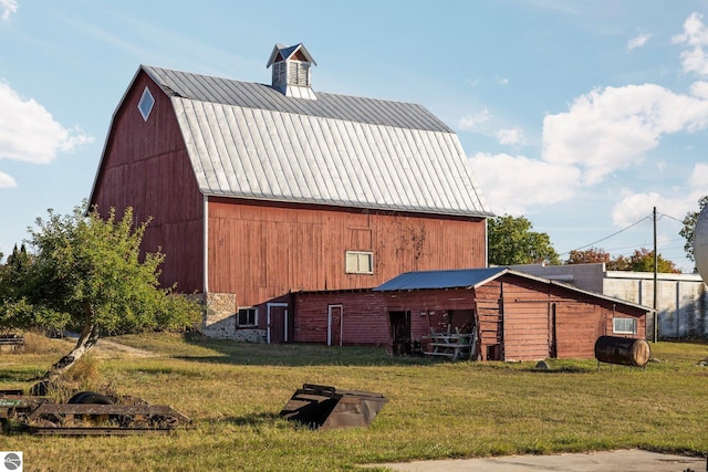 exterior space featuring a lawn and an outdoor structure