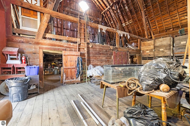 misc room featuring wood walls, hardwood / wood-style floors, high vaulted ceiling, and wood ceiling