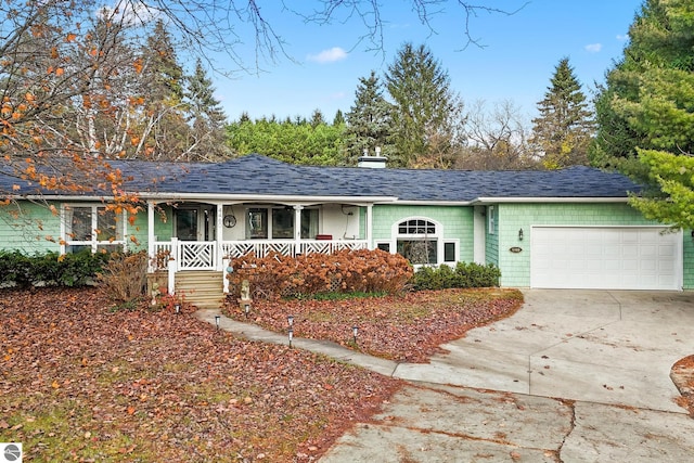 single story home with covered porch and a garage