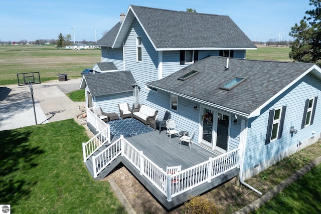 rear view of property with outdoor lounge area, a yard, and a wooden deck