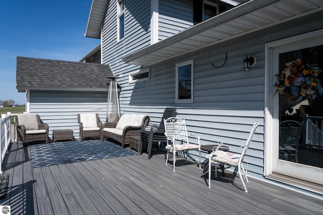 wooden terrace with an outdoor living space