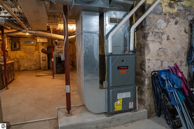 utility room featuring heating unit