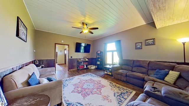 living room with ceiling fan, wood walls, dark hardwood / wood-style flooring, and wood ceiling