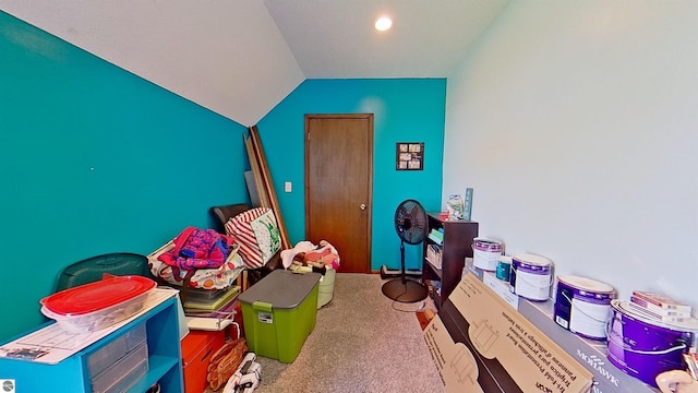 recreation room with carpet and vaulted ceiling