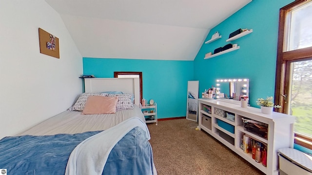 carpeted bedroom featuring lofted ceiling