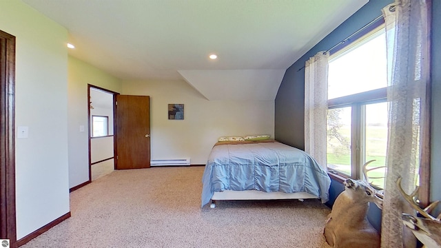 bedroom with carpet, lofted ceiling, and a baseboard heating unit