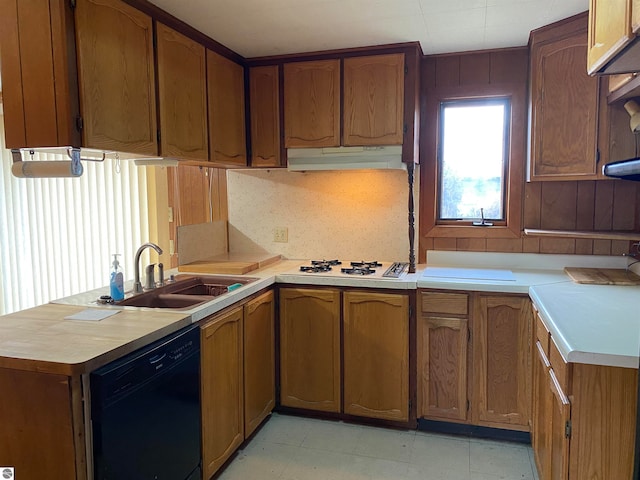 kitchen featuring dishwasher, white gas stovetop, sink, and kitchen peninsula