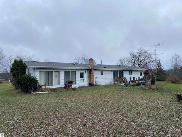 back of house with a lawn and a wooden deck