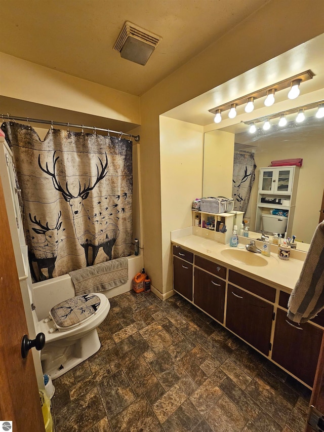 full bathroom with a shower with curtain, stone finish floor, toilet, vanity, and visible vents