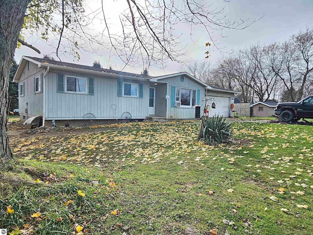 view of front facade with a garage and a front lawn