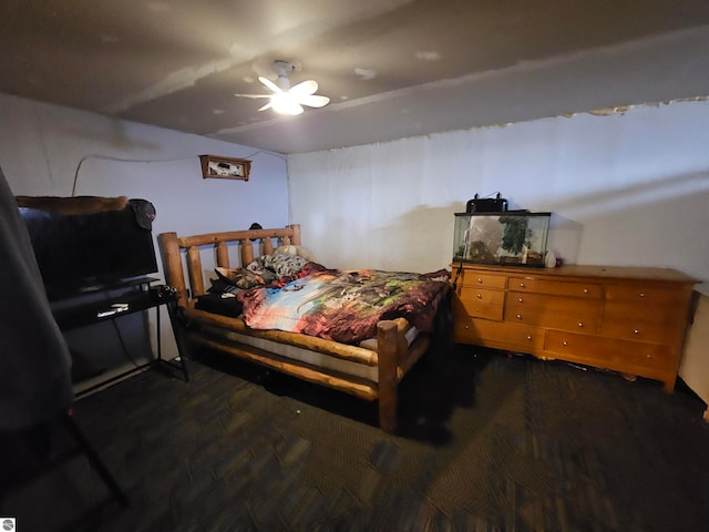 bedroom featuring a ceiling fan and dark wood finished floors