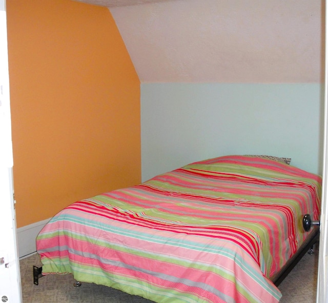 carpeted bedroom with vaulted ceiling