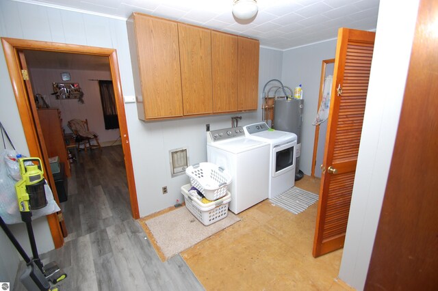 laundry room with cabinets, crown molding, water heater, light hardwood / wood-style flooring, and washing machine and clothes dryer