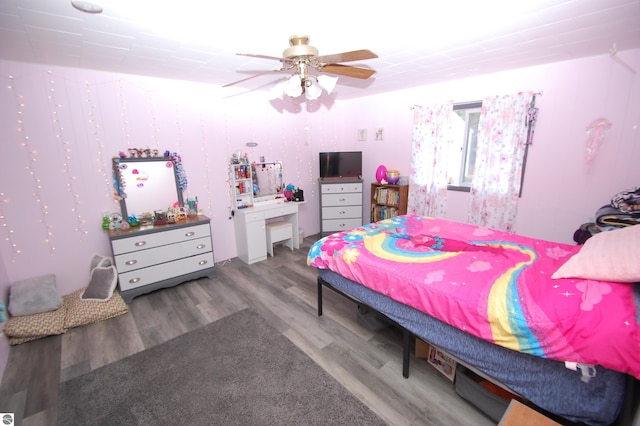 bedroom with ceiling fan and light hardwood / wood-style flooring