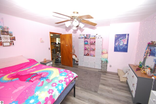 bedroom with hardwood / wood-style flooring and ceiling fan