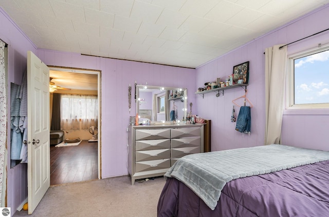 carpeted bedroom featuring multiple windows