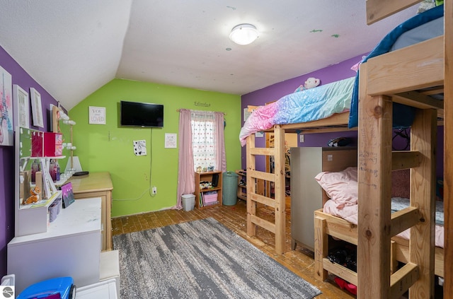 bedroom with wood-type flooring and lofted ceiling