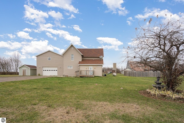 view of side of property featuring a wooden deck, a yard, and a garage