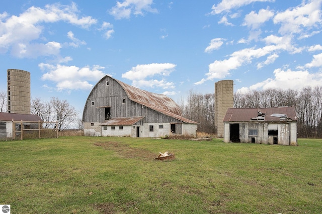 back of property with an outdoor structure and a lawn