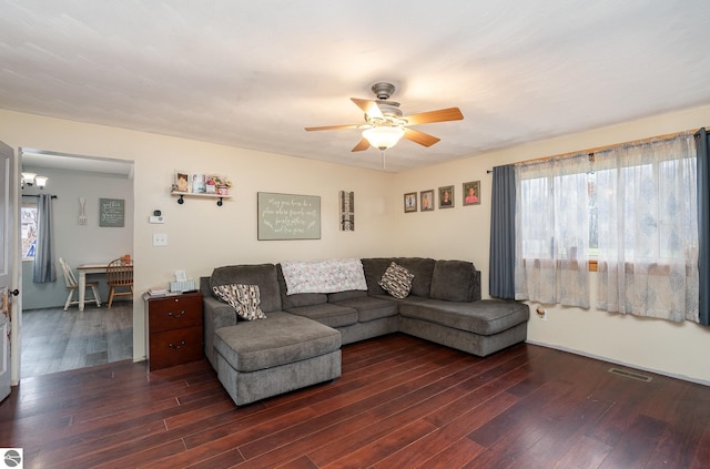 living room with a wealth of natural light, ceiling fan, and dark hardwood / wood-style floors