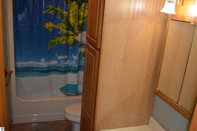 bathroom featuring shower / bath combination with curtain and toilet