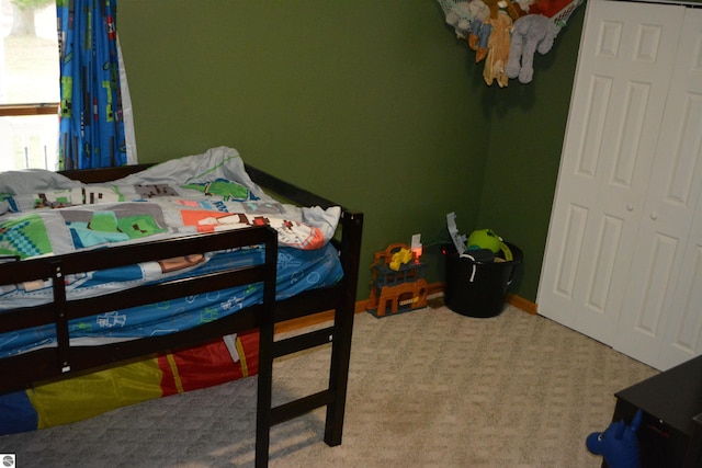 carpeted bedroom with a closet