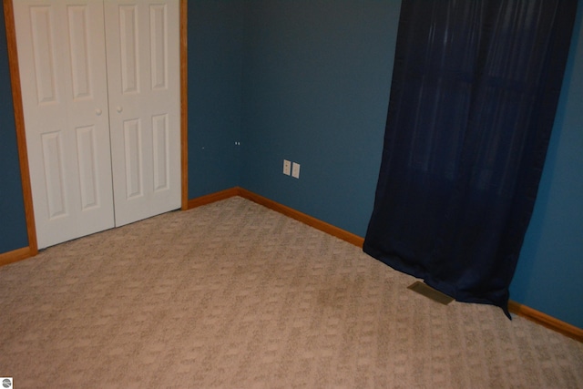 unfurnished bedroom with carpet floors and a closet