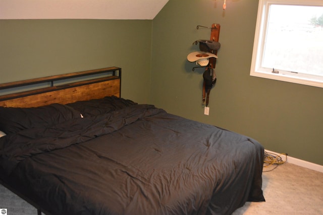 carpeted bedroom featuring vaulted ceiling