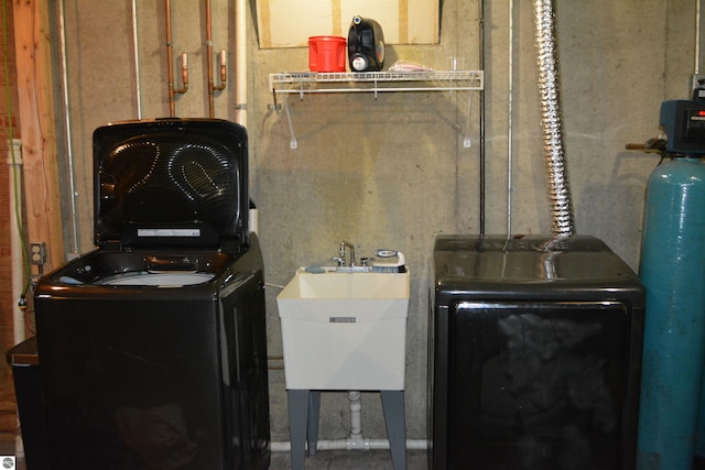 utilities with separate washer and dryer and sink