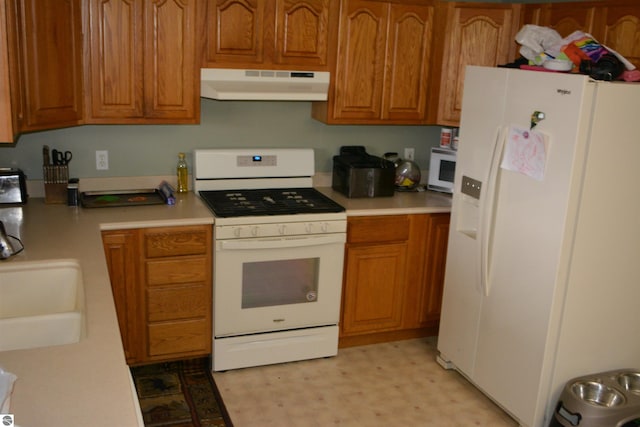 kitchen featuring white appliances and sink