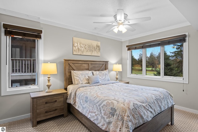 bedroom featuring ceiling fan, crown molding, and carpet