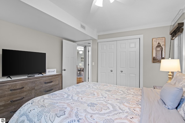 bedroom with ceiling fan and a closet