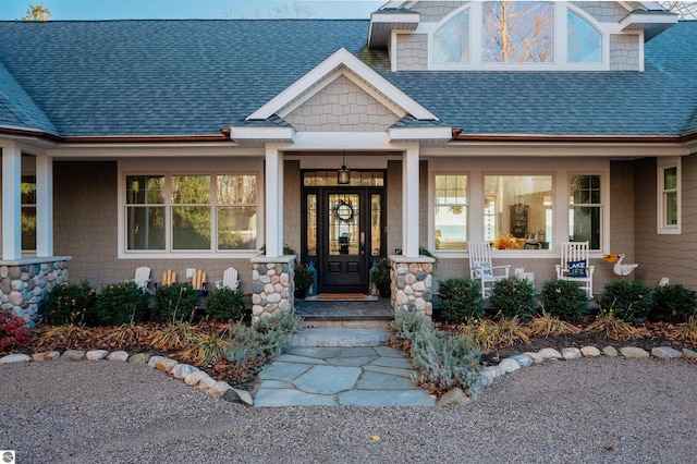 view of exterior entry with a porch