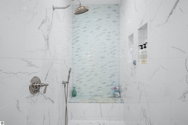 bathroom with a tile shower