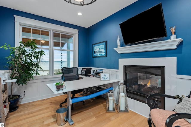 91 S Nanagosa Trl, Suttons Bay, MI 49682 - office area with wood finished floors, a glass covered fireplace, wainscoting, and recessed lighting