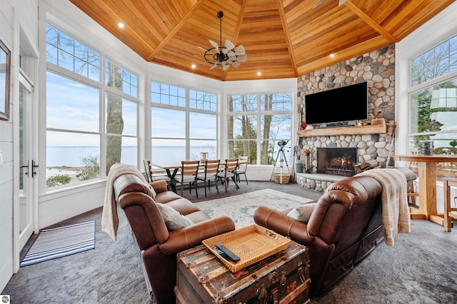 carpeted living room featuring a fireplace, ceiling fan, plenty of natural light, and wood ceiling