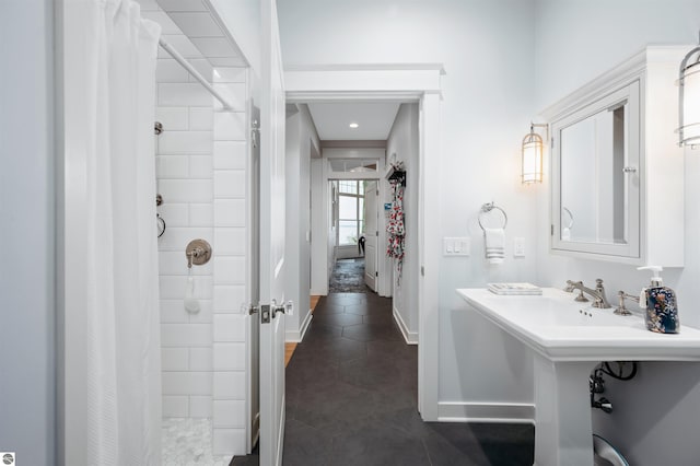 bathroom with curtained shower and tile patterned flooring