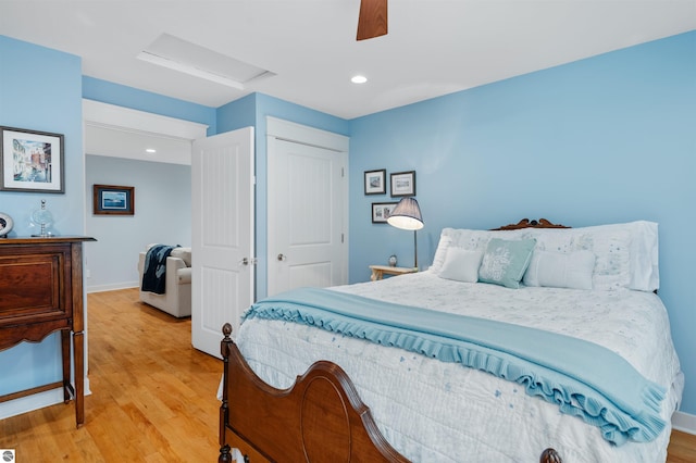 bedroom featuring light wood-type flooring, a closet, and ceiling fan