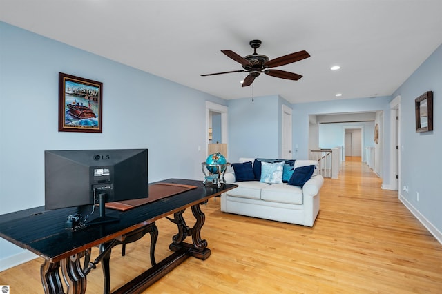 home office with ceiling fan and light wood-type flooring