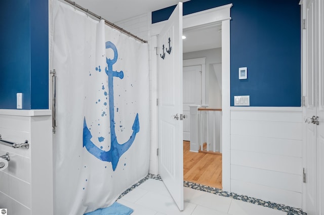 bathroom with tile patterned flooring and a shower with shower curtain