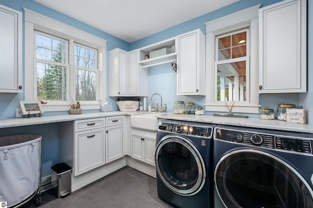 91 S Nanagosa Trl, Suttons Bay, MI 49682 - washroom with washer and clothes dryer, cabinet space, and dark tile patterned flooring