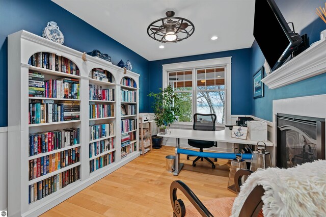 office with ceiling fan and hardwood / wood-style flooring