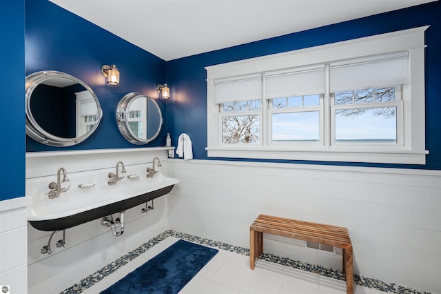 91 S Nanagosa Trl, Suttons Bay, MI 49682 - bathroom with wainscoting, a sink, and tile patterned floors