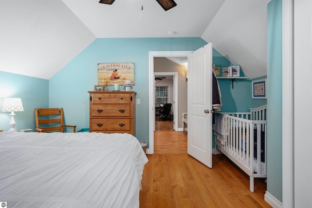 bedroom with light hardwood / wood-style flooring, ceiling fan, and lofted ceiling