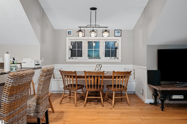 dining room with a chandelier and light hardwood / wood-style flooring