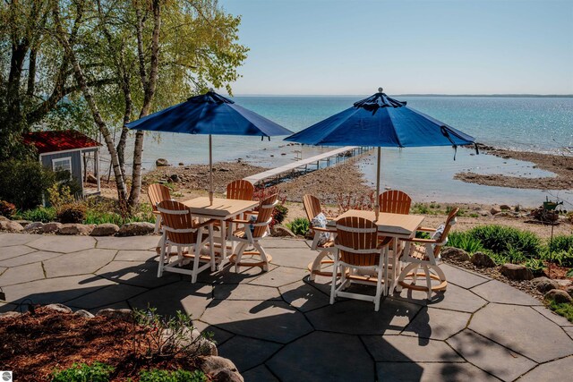 91 S Nanagosa Trl, Suttons Bay, MI 49682 - view of patio / terrace featuring outdoor dining area and a water view