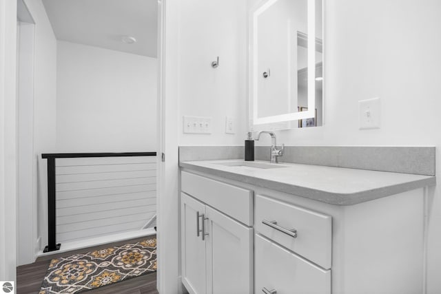 bathroom with hardwood / wood-style floors and vanity