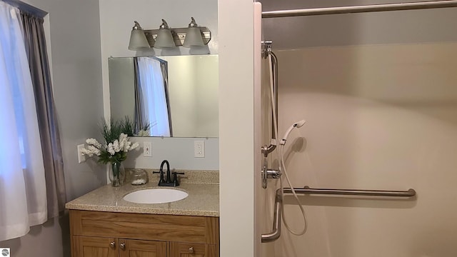 bathroom featuring a shower and vanity