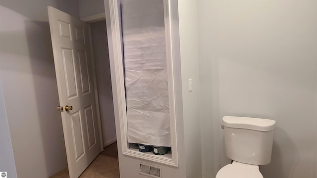 bathroom with tile patterned floors and toilet